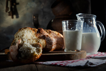 Fresh wheat bread and milk on a village table