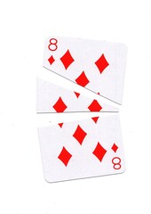 A playing card in the suit of diamonds cut into sharp pieces.