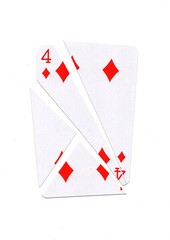 A playing card in the suit of diamonds cut into sharp pieces.
