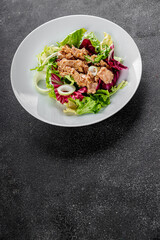 Tuna salad canned fish mixed green leaf lettuce seafood appetizer vegetable dish organic fresh tasty gourmet food background on the table rustic top view copy space vegetarian food pescetarian diet