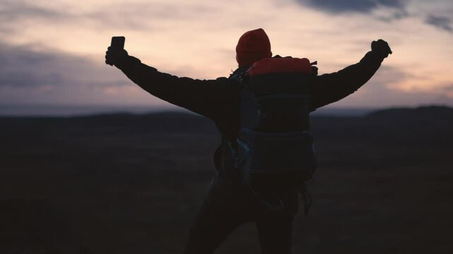 Man Standing on Cliff Overlooking Vast Icelandic Landscape