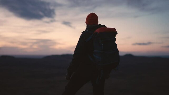 Man Standing on Cliff Overlooking Vast Icelandic Landscape