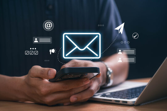 Digital marketer using email marketing tools on laptop and smartphone, sending newsletters and analyzing campaign performance to engage subscribers and grow business through personalized content