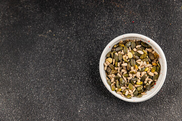 Seed mix bio pumpkin seeds, sunflower seeds superfood natural food dish organic fresh tasty gourmet food background on the table rustic food top view copy space