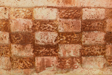 Textured, patterned stone wall in the design of an abstract checkerboard for background or graphic design