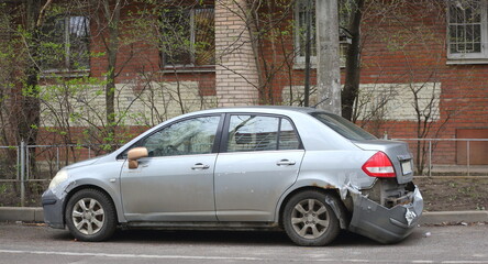 A crashed gray car is parked near an apartment building, Kollontai Street, St. Petersburg, Russia, April 23, 2025