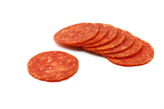 Pile of pepperoni slices on white background
