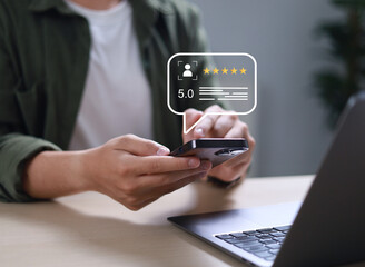 Businessman uses smartphone to provide five-star feedback for customer satisfaction survey, increasing company rating and improving service quality.