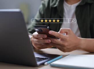 Businessman uses smartphone to provide five-star feedback for customer satisfaction survey, increasing company rating and improving service quality.