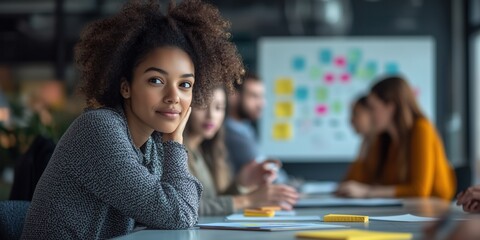 Confident young woman sits at a desk in a modern office, surrounded by a diverse team in a collaborative meeting. Creative atmosphere with colorful sticky notes in the background..