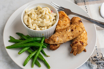 chicken  tenders with green beans and macaroni salad