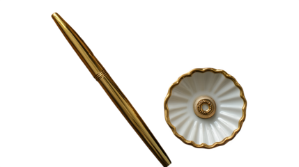 Flatlay of gold pen, ring dish, and linen napkin on wood table