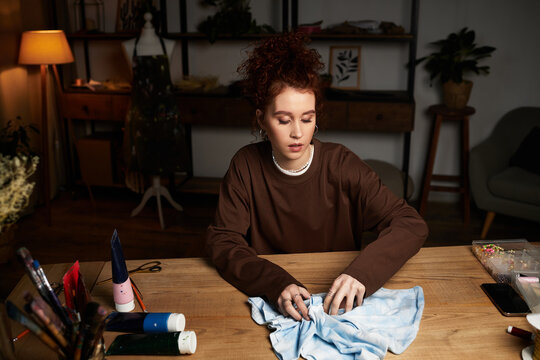 Creative craftswoman transforming fabric in a modern DIY workspace with artistic flair