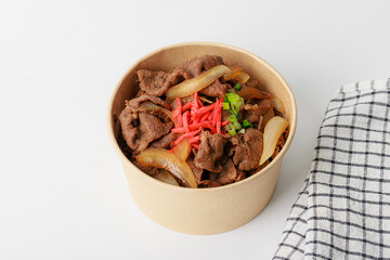 Bowl of beef stir fry with onions and carrots. Gyudon
