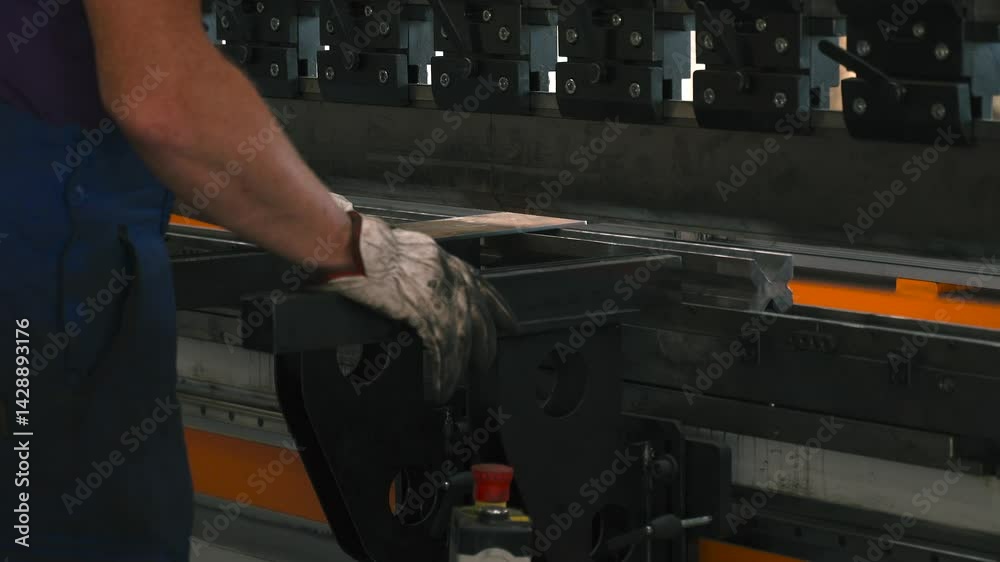 Poster In a bright workshop, a skilled operator uses a bending machine to shape a sheet metal part. Focused on the task, hands maneuver the machine for perfect precision in production.