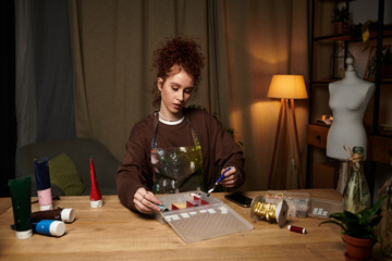Creative young craftswoman engaged in a modern DIY project in a cozy indoor workspace