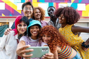 Multiethnic group of young friends meeting and having fun outdoors - Multiracial happy and stylish teen students bonding in the city, concepts about youth, teenagers lifestyle and diversity