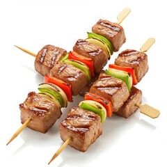 Close up of three kewers with grilled meat and vegetables on a white background studio shot