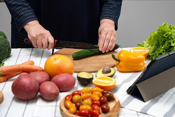 woman cooking online recipe with tablet. Meal Time