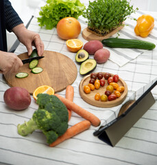 woman cooking online recipe with tablet. Meal Time