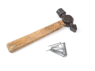 old hammer with wooden handle and nails on white background