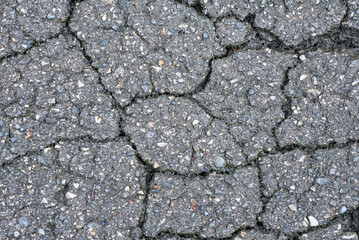 Cracks on the asphalt road. Asphalt texture. Abstract background