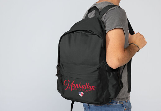 Black Backpack Held by Faceless man