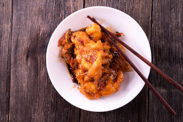 Sweet and sour chicken. Fried meat. Food concept. Chopsticks