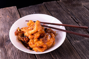 Sweet and sour chicken. Fried meat. Food concept. Chopsticks