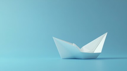 Simple origami paper boat on a light blue background