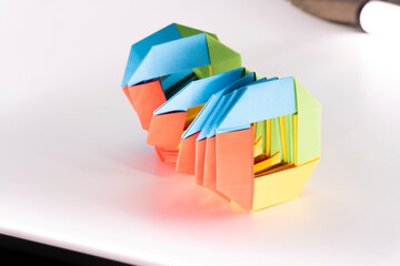 Toy paper rainbow on white background, color spiral for play. paper spring. paper crafts. toy...
