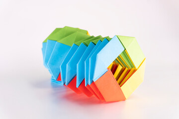 Toy paper rainbow on white background, color spiral for play. paper spring. paper crafts. toy...