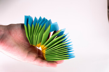 Toy paper rainbow on white background, color spiral for play. paper spring. paper crafts. toy...