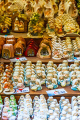 Colorful christmas nativity scenes figurines with price tag filling market stall shelves
