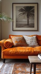 Fototapeta premium Orange sofa with pillows and framed artwork in a living room setting.