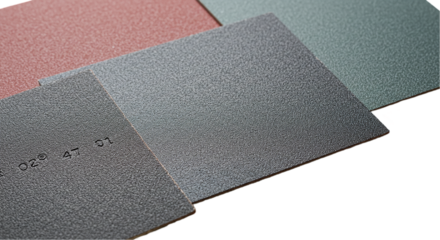 A close up of several textured square samples in different colors with a black background visible area