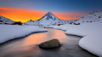 A stunning winter landscape featuring a majestic mountain, a flowing river, and a colorful sunset reflecting off the snow-covered terrain.