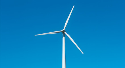 Fototapeta premium Wind Turbine Under a Clear Blue Sky Generating Renewable Energy Power in a Sustainable Environment