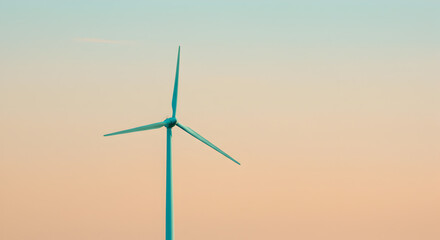 Fototapeta premium Single Wind Turbine Spinning Silently Against Pastel Peach and Teal Sunset Sky Creating Clean Energy