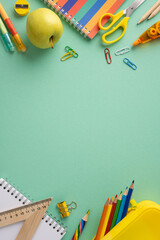 Organized vertical school supplies including pencils, notebooks, and stationery displayed on a green surface © ActionGP