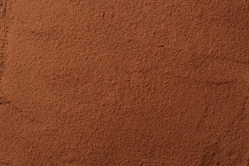 Cocoa powder background. Organic food with useful properties. Top view of cocoa texture