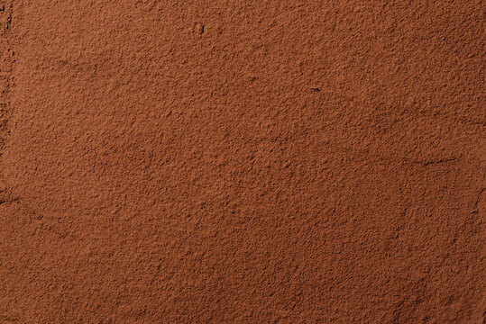 Cocoa powder background. Organic food with useful properties. Top view of cocoa texture