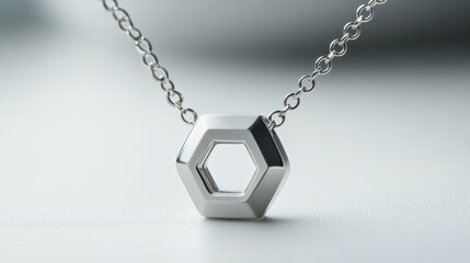 Small hexagon pendant on fine platinum chain, isolated on white background