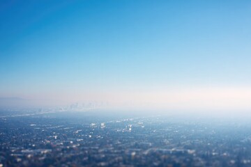 Fototapeta premium aerial view of city shrouded in pollution with clear blue sky above showcasing contrasts between urban sprawl and nature