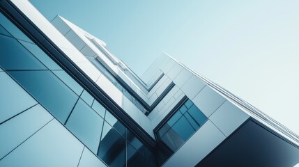 A tall building with a lot of windows and a blue sky in the background