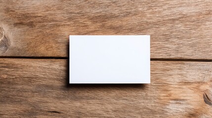 Blank white card on wooden table, simplicity and purity in a clean space