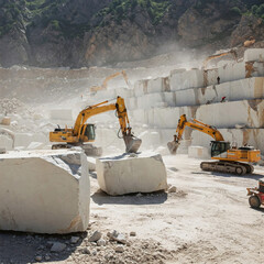 Heavy machinery excavating large blocks of white marble in a dusty quarry environment