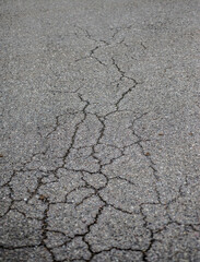 Cracks on the asphalt road. Shallow depth of field.