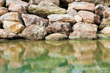 Retaining breakwater wall built with stone boulders