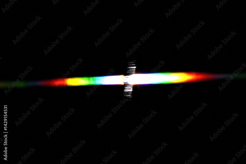 Poster A vibrant spectrum of colors emerges from a dark background, creating an intriguing visual effect reminiscent of light diffraction.